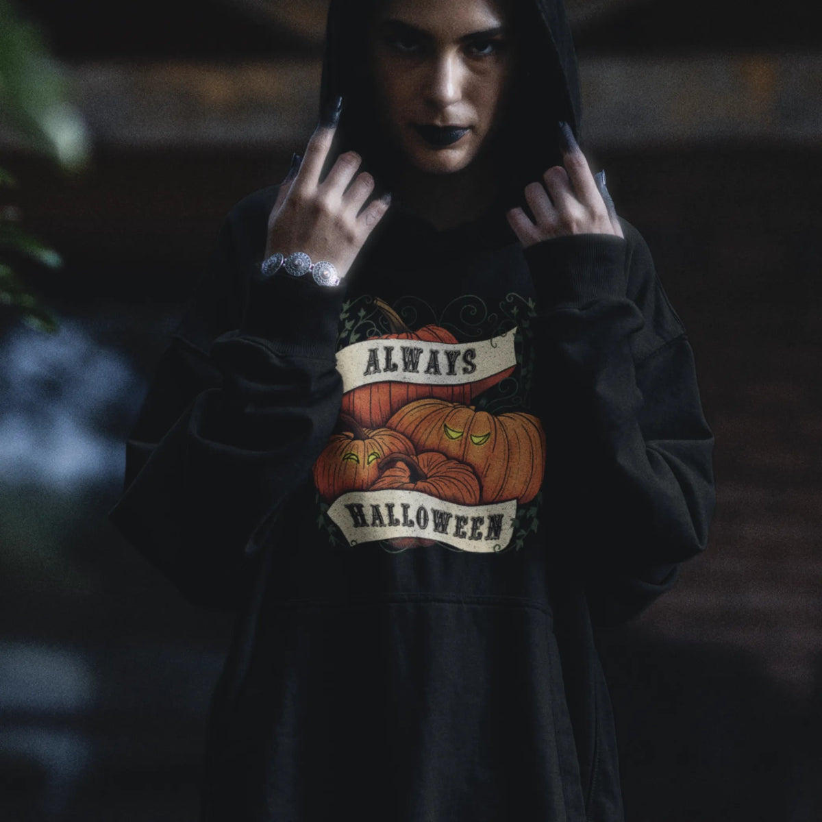 Adult wearing our black pumpkin hoodie